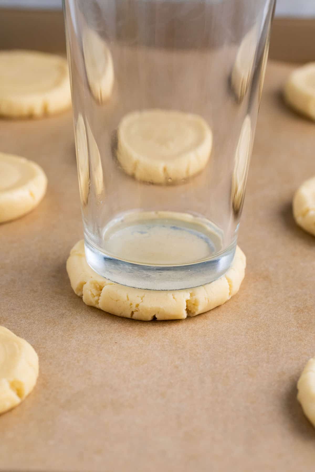 shortbread cookies smashed with a glass on a cookies sheet.