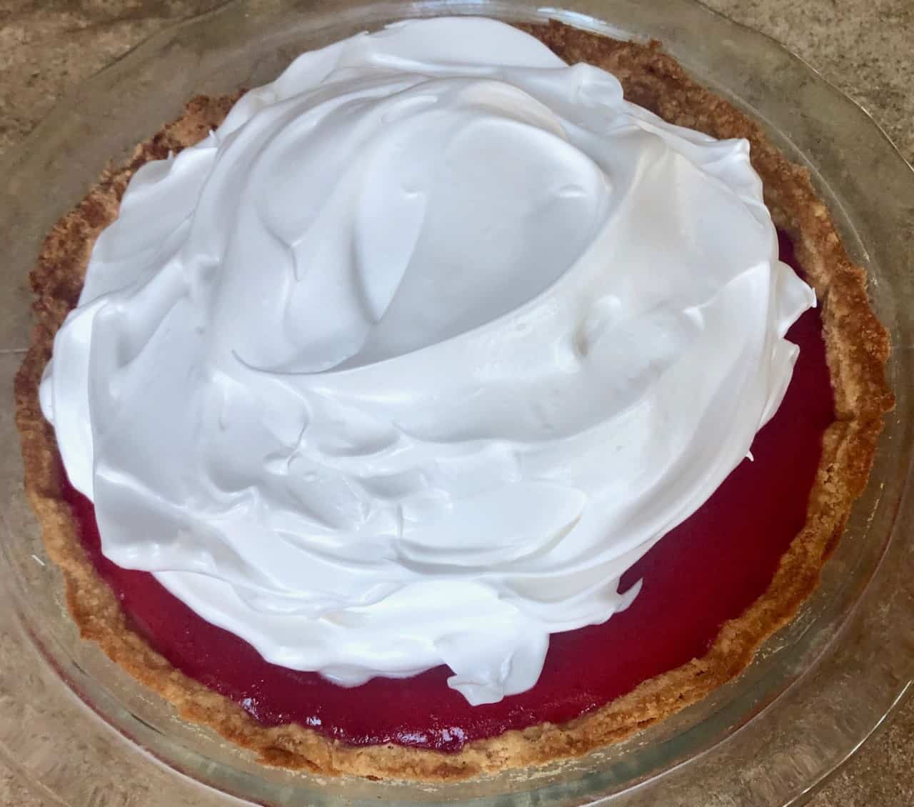 lemon cranberry pie with fresh meringue on top.