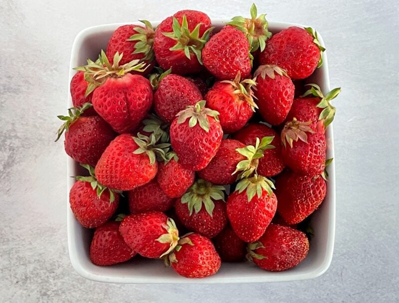 a bowl of fresh hood strawberries.