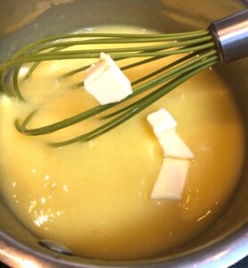 adding butter to lemon curd