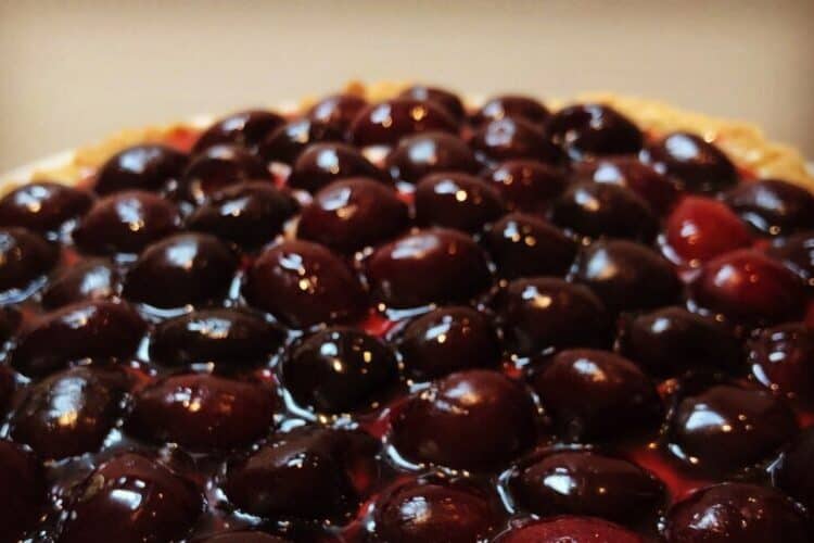 cherry tart with pastry cream and fresh cherry syrup.