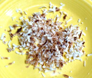 toasted coconut on a yellow plate that was toasted in the microwave