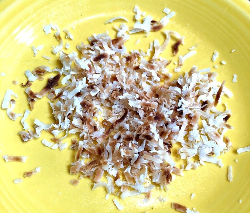 shredded coconut on a plate that has been toasted in the microwave.