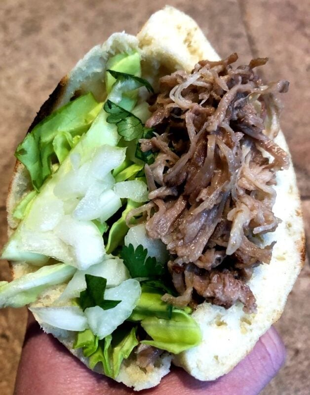 Kalua Pork in a Homemade Pita with cabbage and onion.