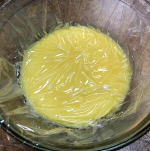 lemon curd with plastic wrap for chilling