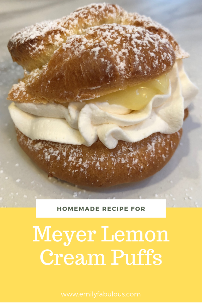 meyer lemon cream puff filled with lemon curd and fresh whipped cream sprinkled with powdered sugar