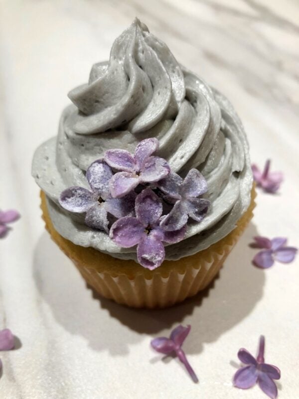 lilac cupcake with candied lilacs as garnish