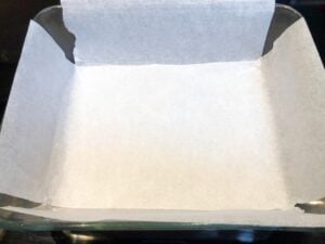 pan prepared with parchment for snickers bars