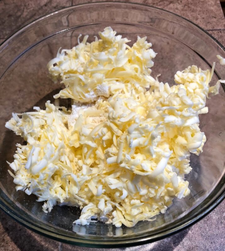grated cold butter in a glass bowl.