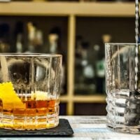 modern negroni cocktail in a low ball with orange peel granish