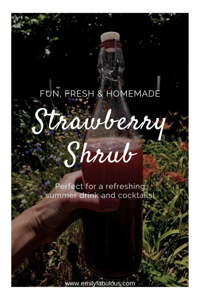 fresh fruit shrub in a bottle being held outside with flowers behind