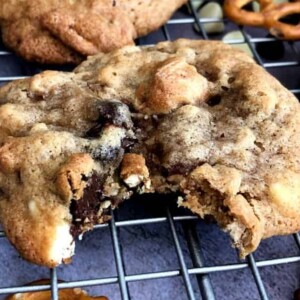 kitchen sink chocolate chip cookie with a bite taken out