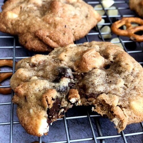 kitchen sink cookies made with choclate chips and trail mix and pretzels with a bite taken out