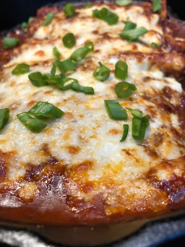 chile relleno enchiladas with sliced green onion