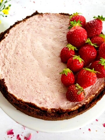 Instant Pot Strawberry Cheesecake on a cake stand