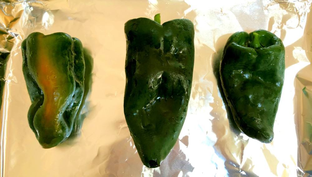 poblano pepper on a baking sheet with tin foil for roasting