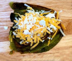 roasted poblano pepper cut open and stuffed with cheese