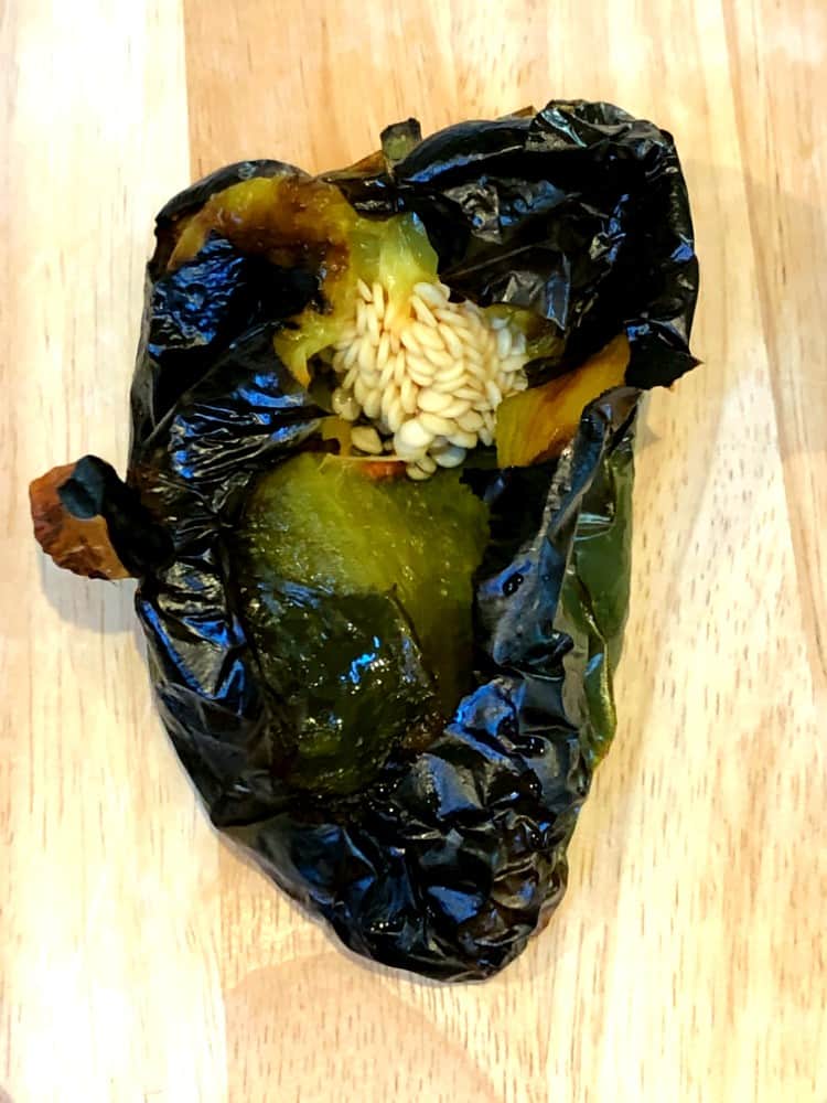 roasted poblano pepper cut open to show seeds.