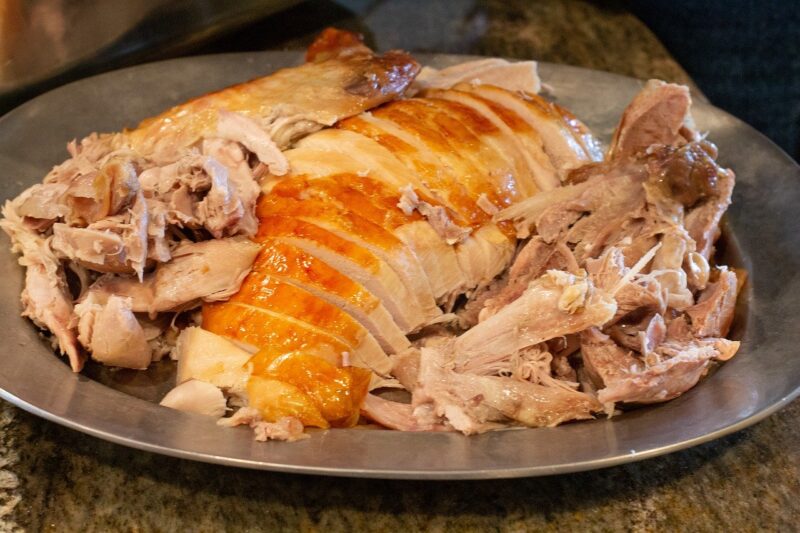 roasted turkey cut into pieces on a serving platter.