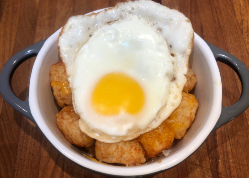 air fryer tater tots wit a fried egg on top