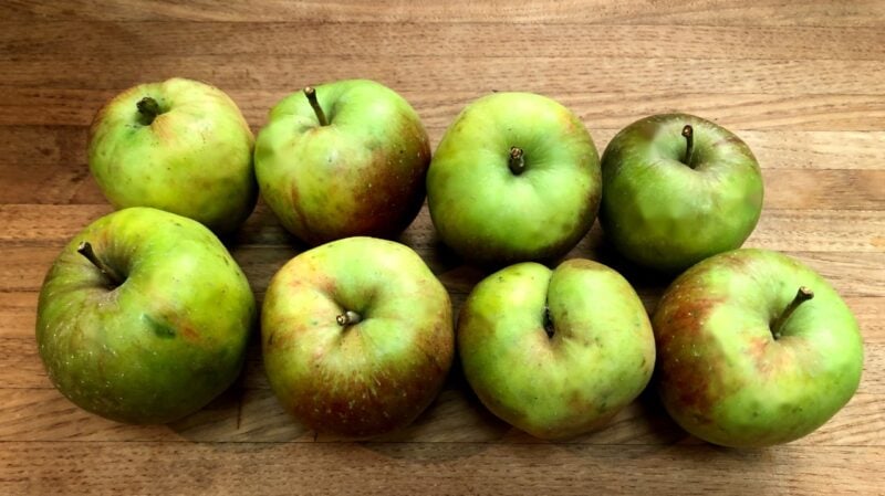 heirloom green apples on a cutting board