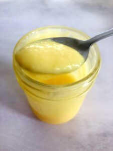 homemade lemon curd in a jar with a spoon