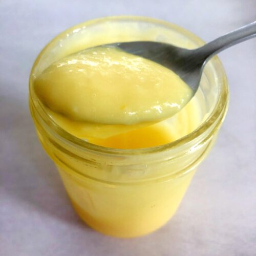 homemade lemon curd in a jar with a spoon
