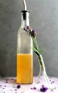 honey lavender syrup in a bottle with dried lavender buds in a vase