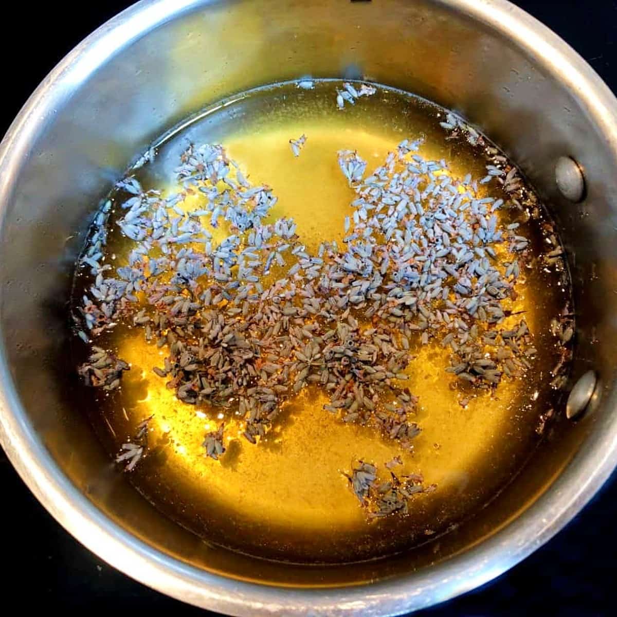 lavender, water, and honey in a saucepan.