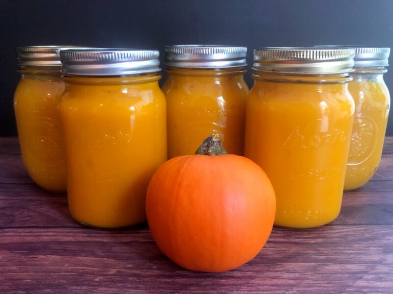 jars of instant pot pumpkin puree and a pumpkin