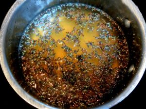 lavender buds steeping in honey and water after boiling