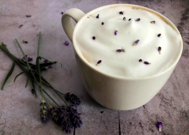 honey lavender latter in a mug with fresh lavender buds
