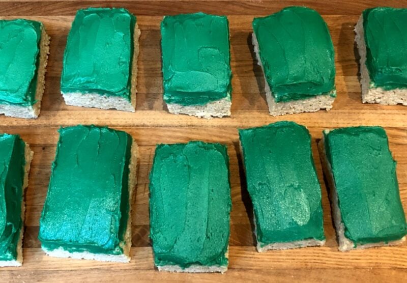 rectangles rice krispie treats with green buttercream frosting.