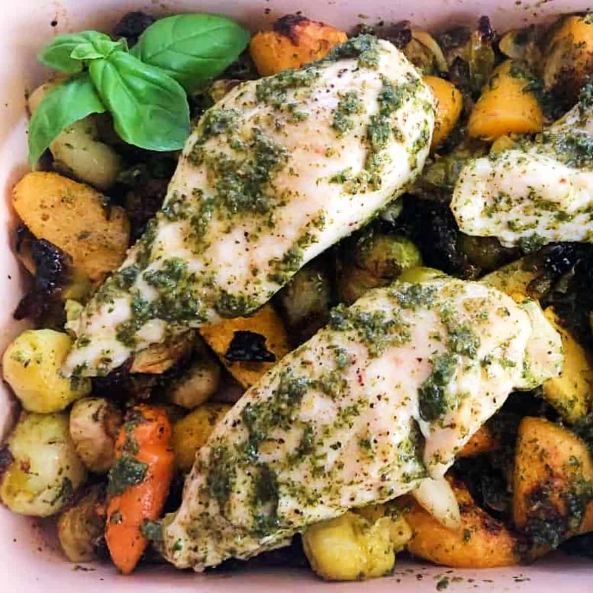baked chicken with pesto and vegetables.