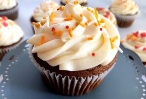 pumpkin molasses cupcakes with caramel apple frosting and fall sprinkles