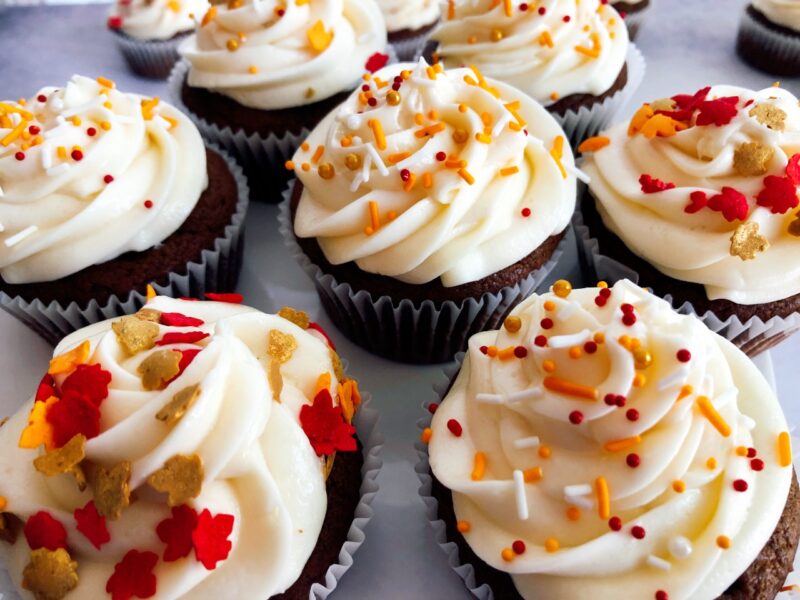 pumpkin molasses cupcakes with caramel apple frosting and sprinkles