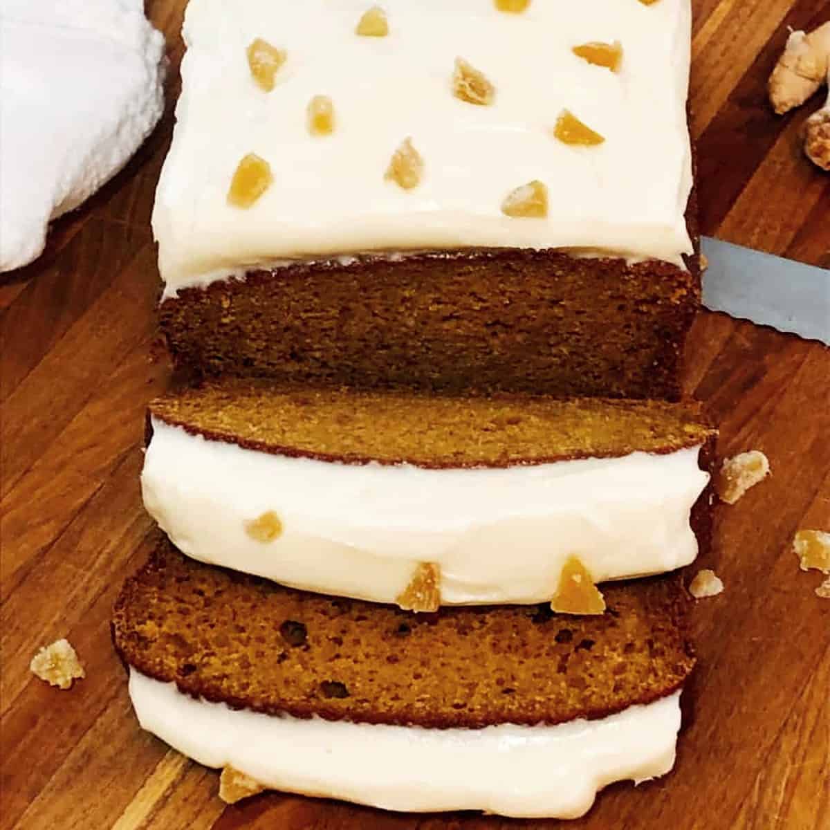 sliced pumpkin bread with cream cheese frosting and candied ginger