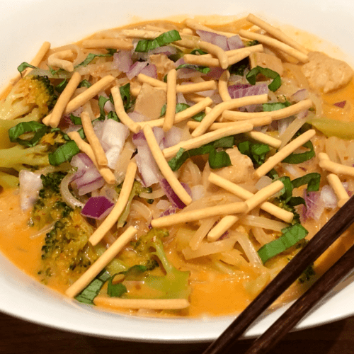 red curry soup with noodles and chow mein on top
