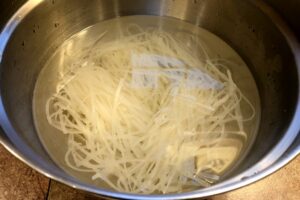 rice noodles in a bowl of hot water