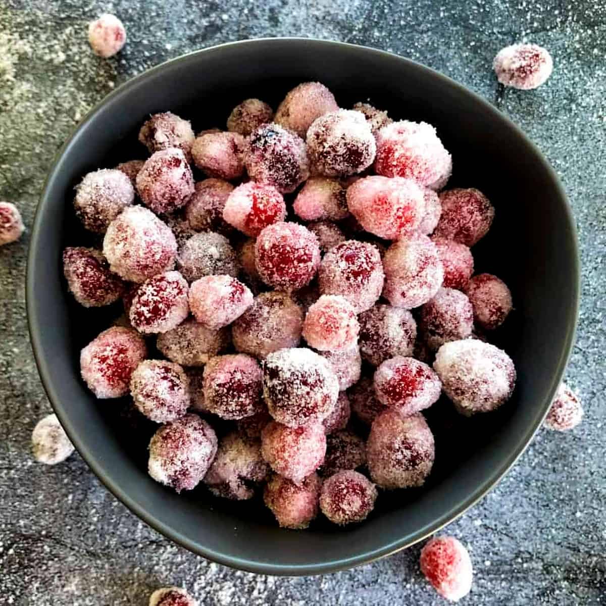 boozy-candied-cranberries-in-a-bowl-with-sugar