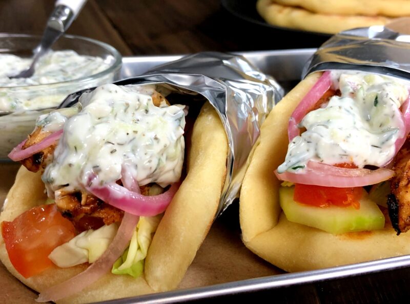 chicken gyros wrapped in foil with tzatziki sauce