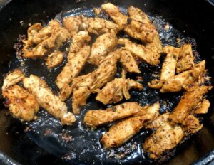 chicken pieces in a pan for gyros
