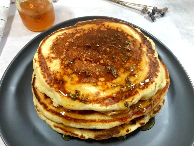 lavender pancakes with lavender honey on top and on the side