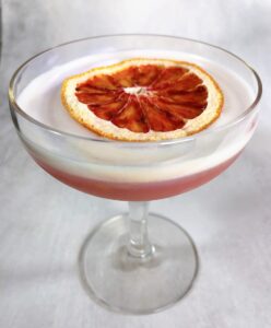 blood orange cocktail with an orange garnish