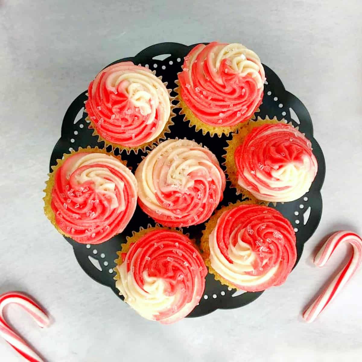 candy cane cupcakes on a cake stand