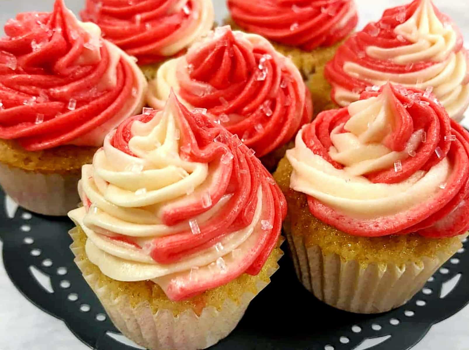 candy cane cupcakes swirled with peppermint buttercream frosting.