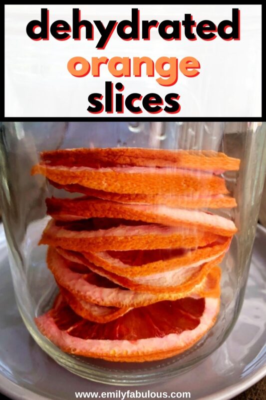 dehydrated oranges stacked in a glass jar for storage