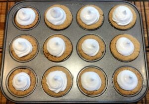 graham cracker cups with chocolate and meringue on top