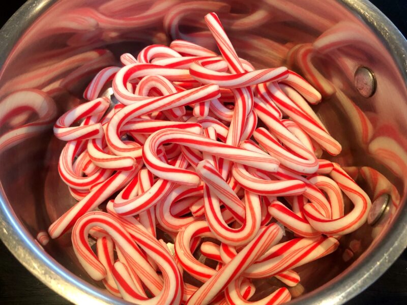mini candy canes in a saucepan to make syrup