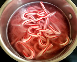 mini candy canes in a pot with water
